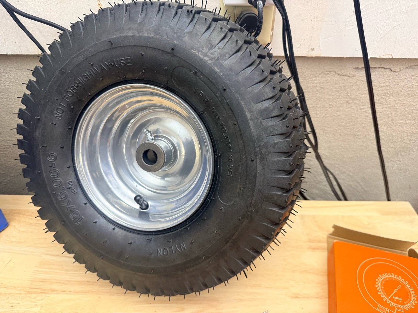 lawn mower tire with a shiny silver rim