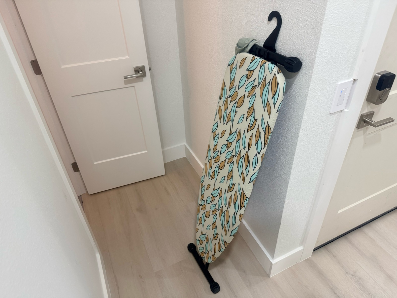 ironing board leaning against wall