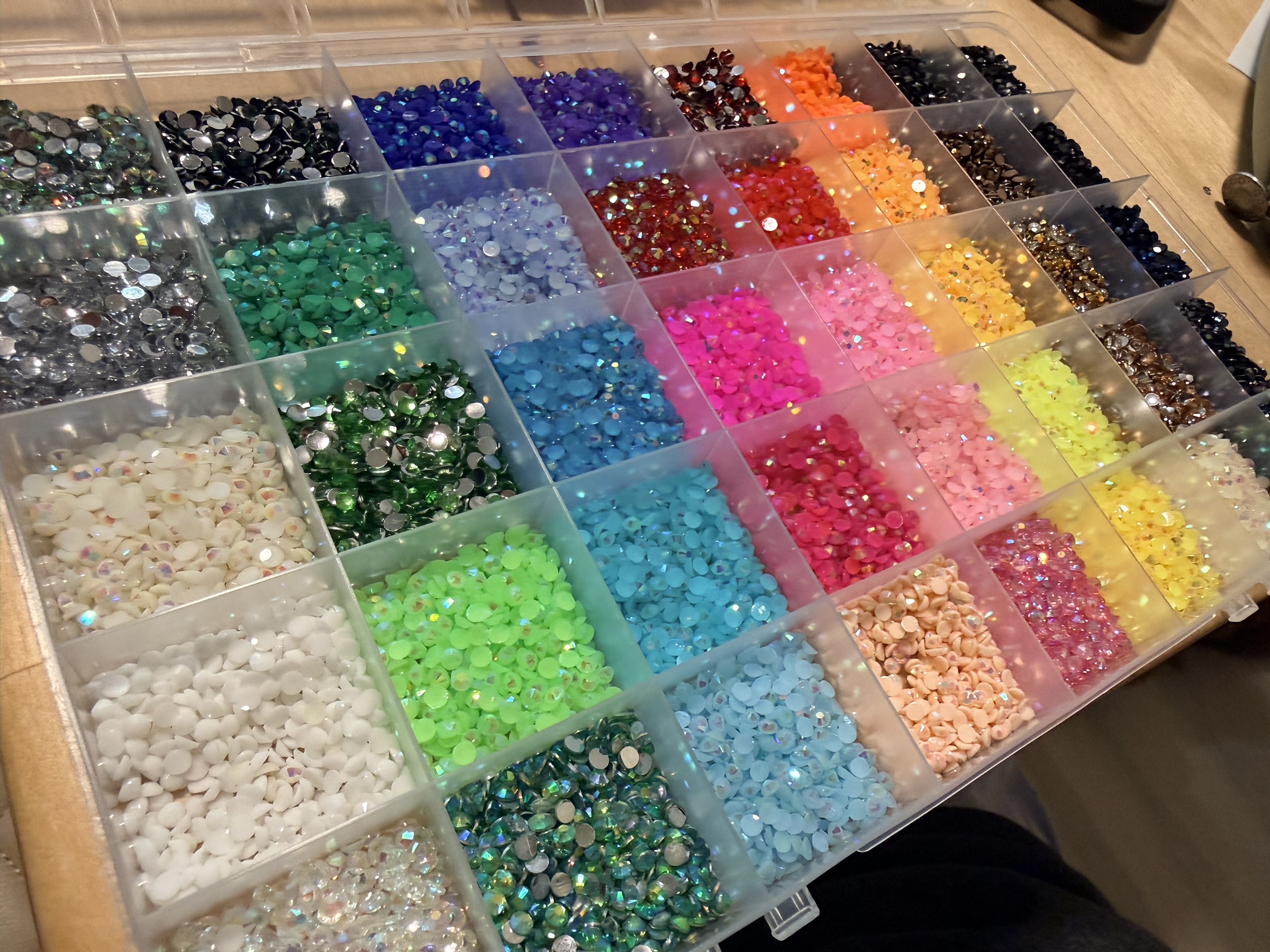 A case filled with 40 different colors of rhinestones.